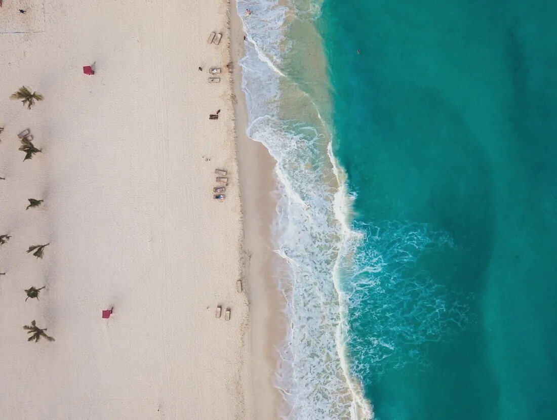 Aerial view of white sand and turquoise surf on the beach at Cancún