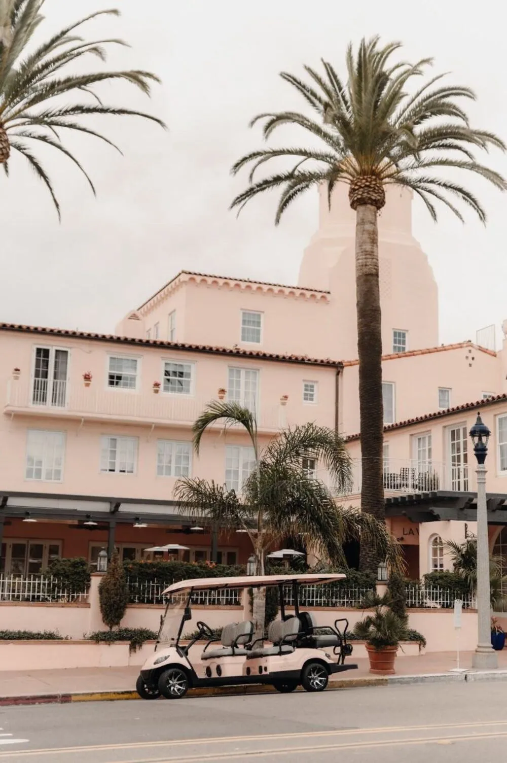 Palms over the pink facade of a historic seaside hotel in La Jolla, San Diego